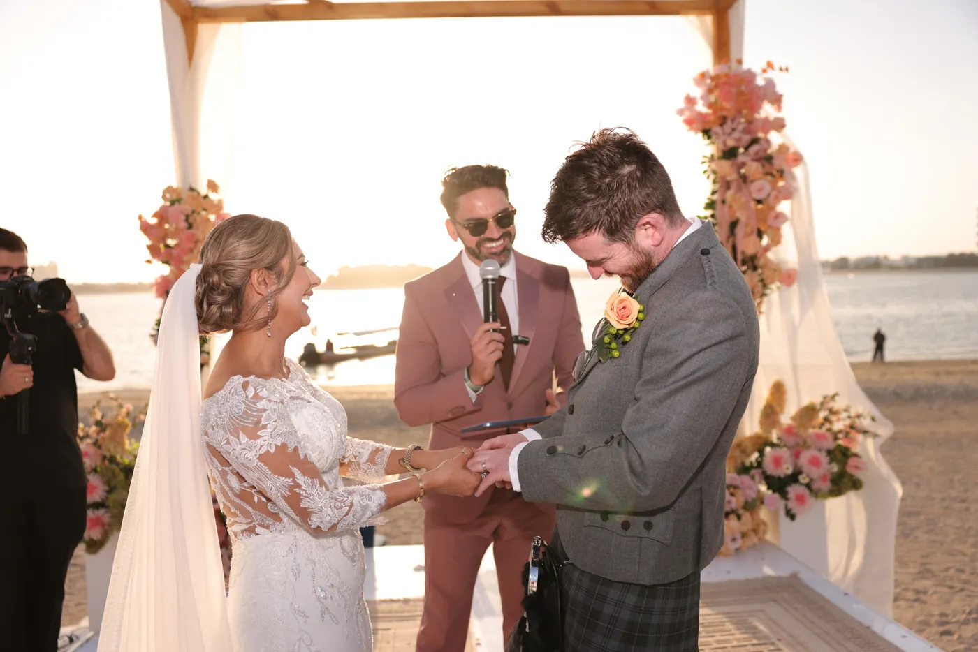 Darryl Rees officiating the ring exchange at a Dubai beach wedding ceremony