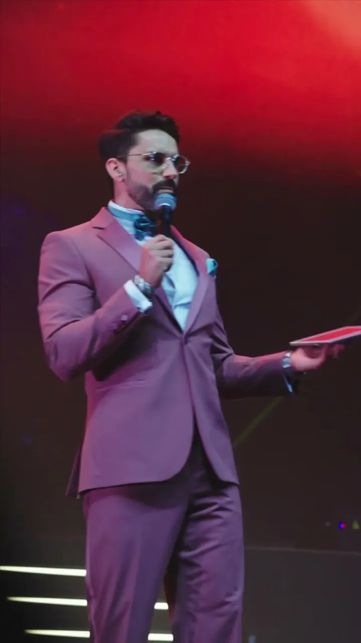 Darryl Rees hosting on stage as MC at a Dubai event