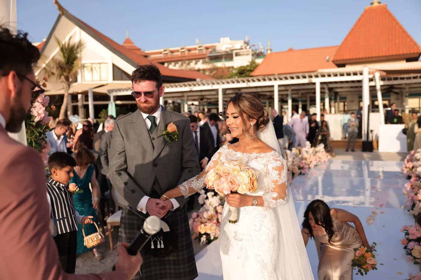Darryl Rees welcoming the bride and groom at a beachfront wedding in Dubai