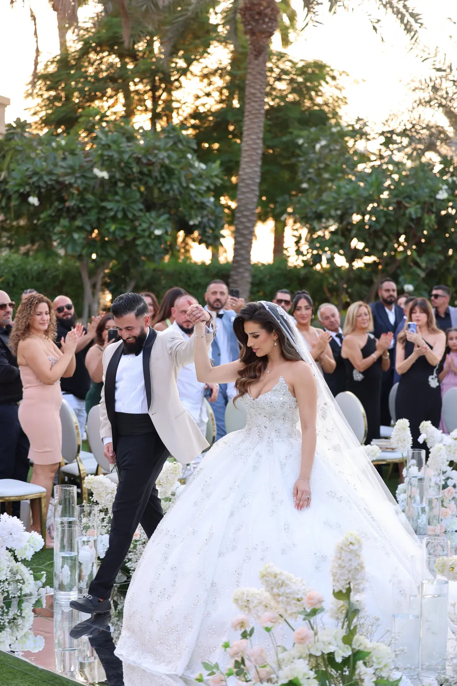 Bride and groom celebrating with guests at their Dubai garden wedding