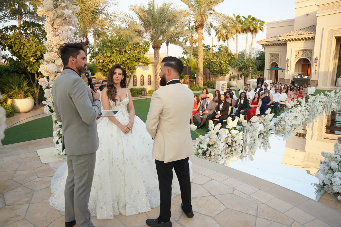 Darryl Rees officiating an outdoor wedding ceremony in front of guests in Dubai
