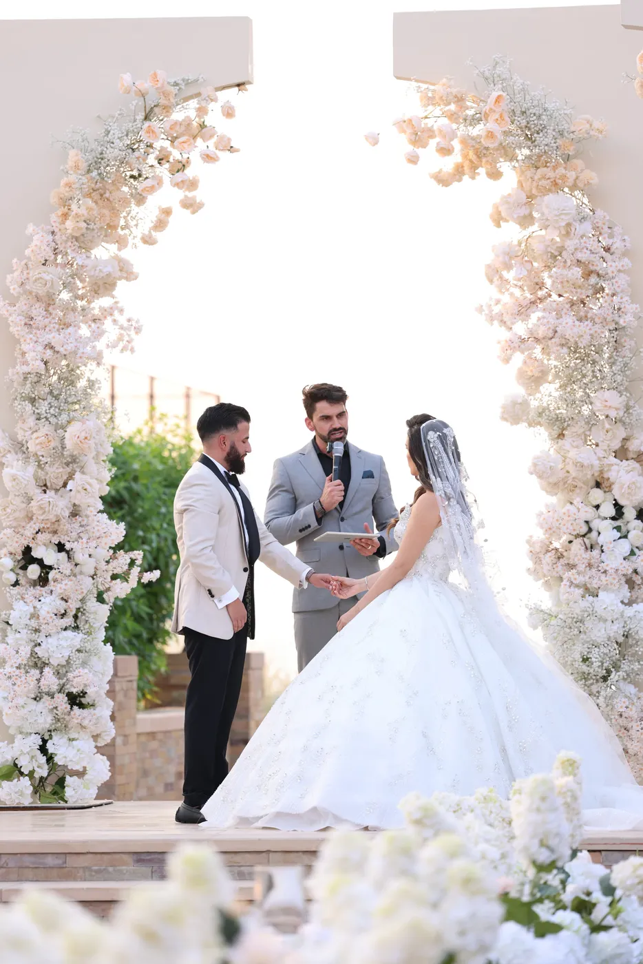 Bride and groom exchanging vows with Darryl Rees as their wedding celebrant